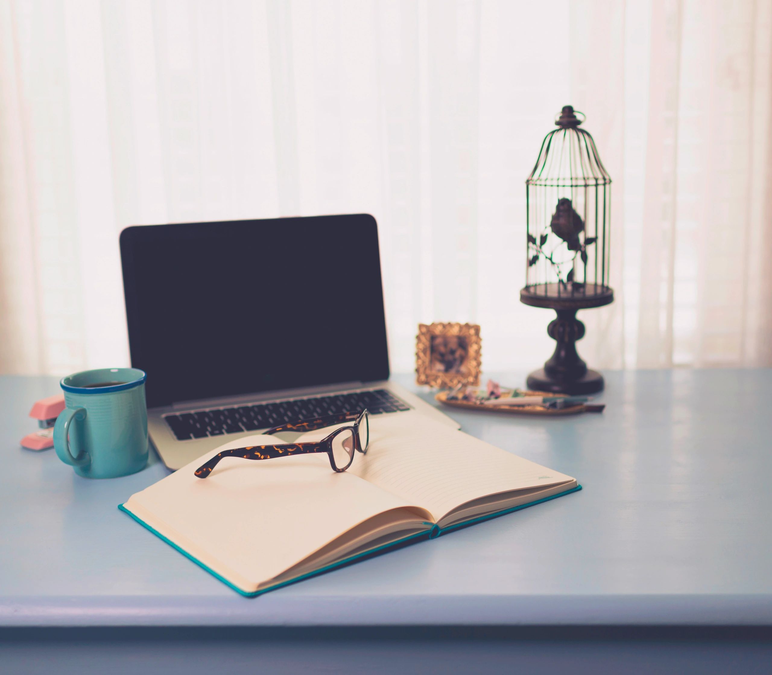 Writing desk with laptop and notebook