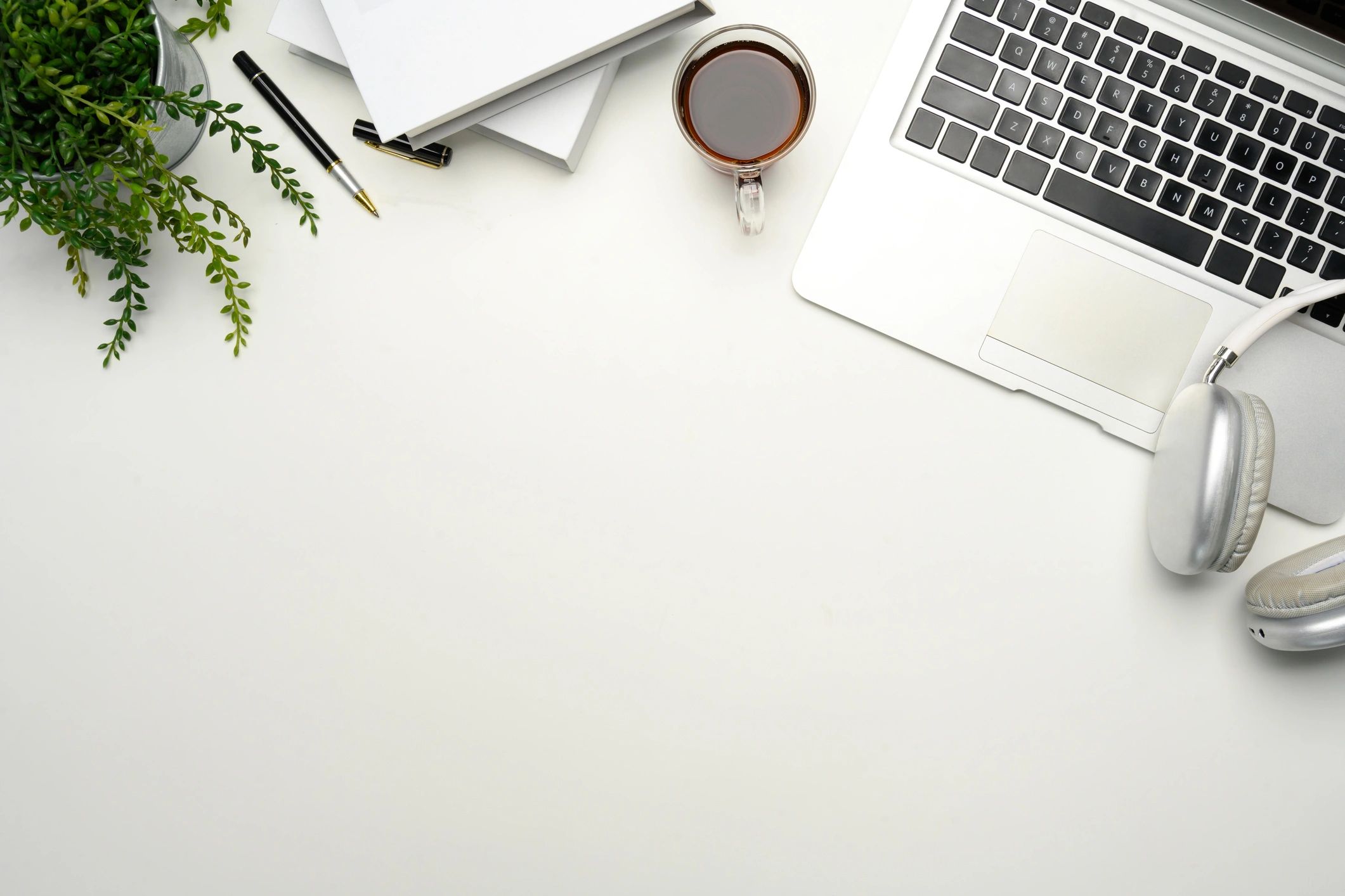Writing desk with laptop and notebooks