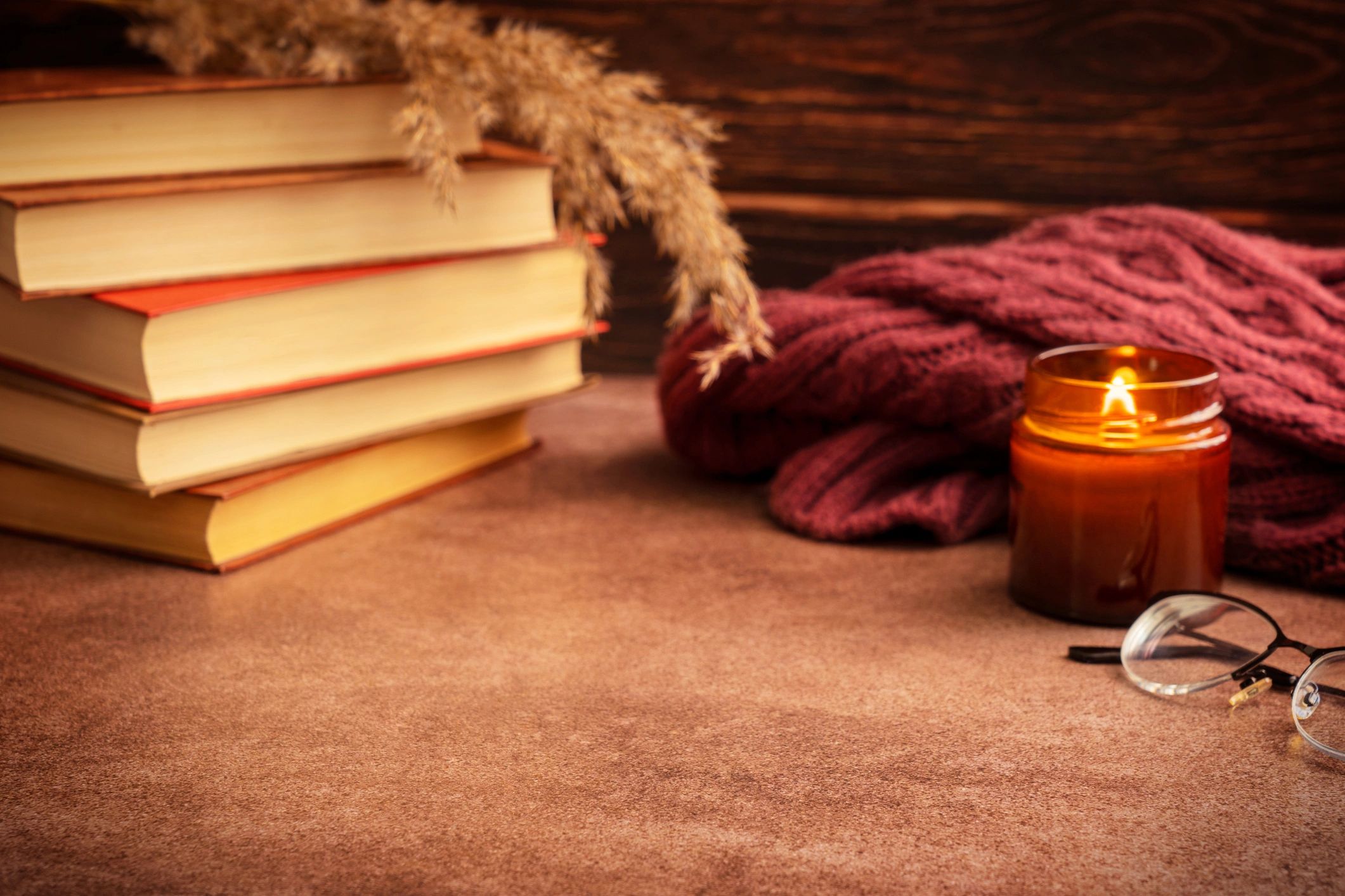 Cozy reading scene with books and a candle