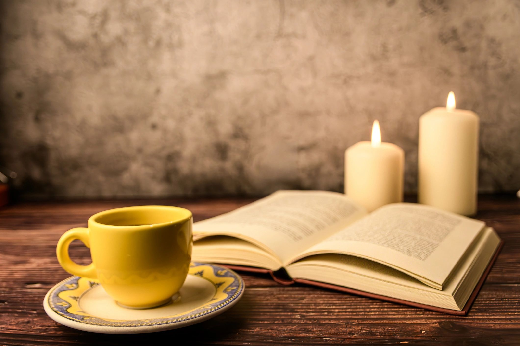 Open book and candle still life used as a decorative reader avatar